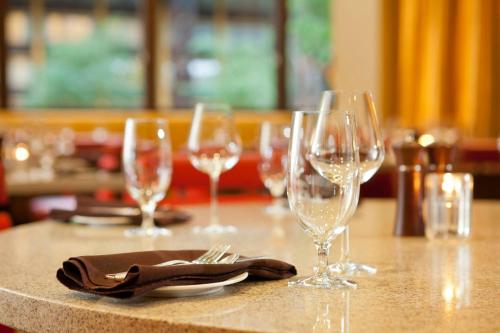 a table with several wine glasses and a napkin at Seattle Airport Marriott in SeaTac
