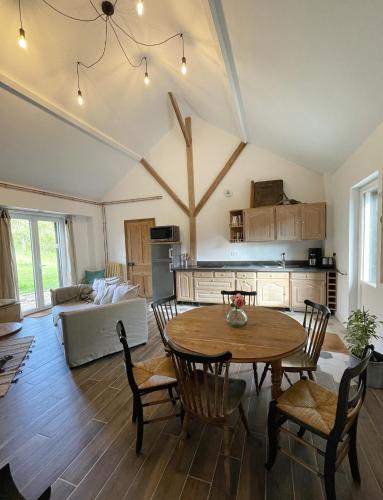 une cuisine et un salon avec une table et des chaises dans l'établissement Les gîtes de la Courtille, à Équihen-Plage