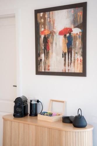 a painting of people walking in the rain with umbrellas at TheNest in Mărişel
