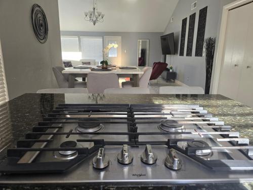 a stove top in a kitchen with a living room at 1976HoustonGem Luminous PvTPool & HotTub DT20mins for LRG Families 6Beds 2Bath in Houston