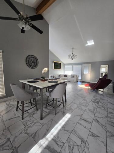 a living room with a ceiling fan and a table and chairs at 1976HoustonGem Luminous PvTPool & HotTub DT20mins for LRG Families 6Beds 2Bath in Houston