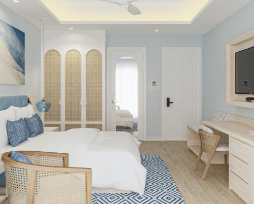 a bedroom with a large white bed and a desk at Eriyadu Island Resort in Reethi Rah