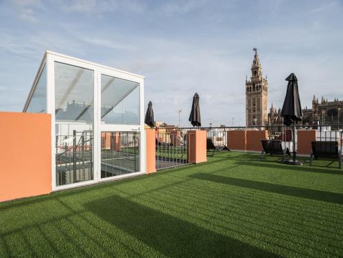a rooftop patio with a view of the big ben clock tower at U-Sense Sevilla Santa Cruz in Seville