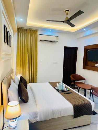 a hotel room with a bed and a television at The Classic Crowne at Delhi Airport in New Delhi