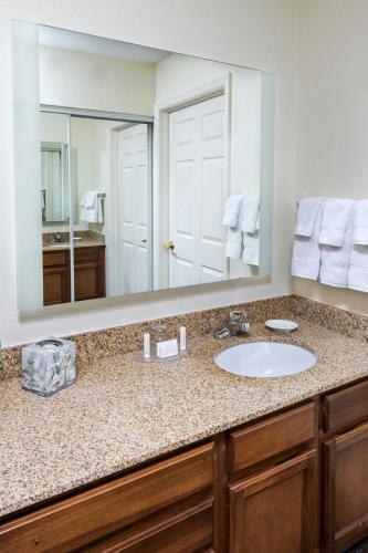a bathroom with a sink and a large mirror at Residence Inn Huntsville in Huntsville