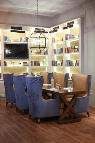 a dining room with a table and chairs and bookshelves at Westfields Marriott Washington Dulles in Chantilly