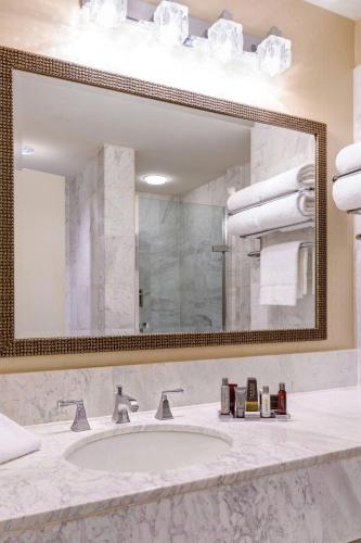 a bathroom with a sink and a large mirror at Westfields Marriott Washington Dulles in Chantilly