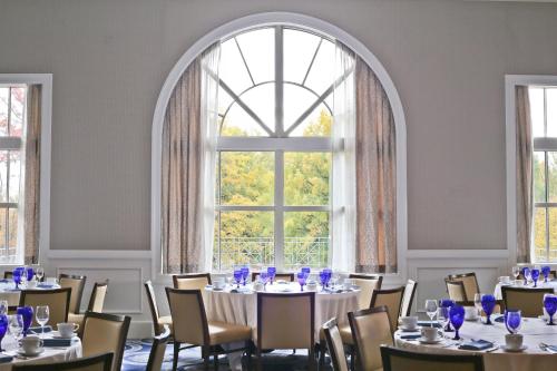 a room with tables and chairs and a large window at Westfields Marriott Washington Dulles in Chantilly