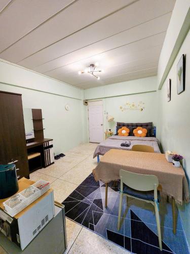 a bedroom with a bed and a table and a tv at 703-STP Homely room Free Wi-Fi and Near BTS line in Bangkok