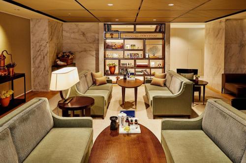 a living room with couches and a table at JW Marriott Dongdaemun Square Seoul in Seoul