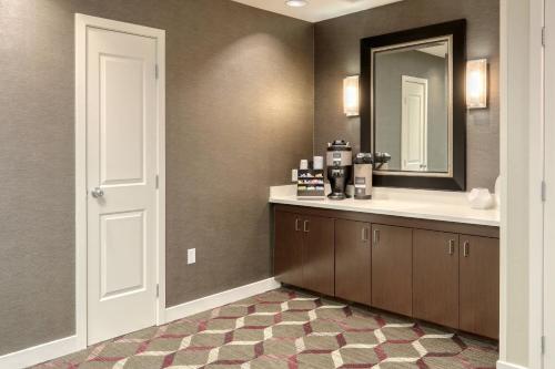 a bathroom with a sink and a mirror at Residence Inn by Marriott Woodbridge Edison/Raritan Center in Woodbridge