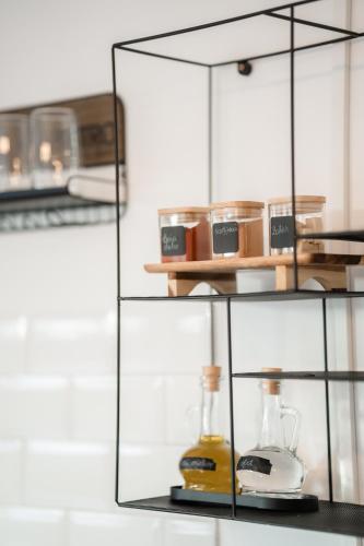 a glass shelf with a blender and other items on it at TheNest in Mărişel