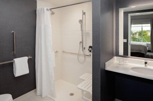 a bathroom with a shower and a toilet and a sink at Residence Inn by Marriott Detroit Farmington Hills in Farmington Hills