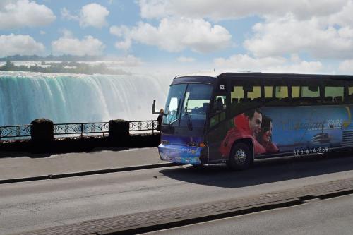 a bus driving in front of a waterfall at Niagara Falls Marriott on the Falls in Niagara Falls