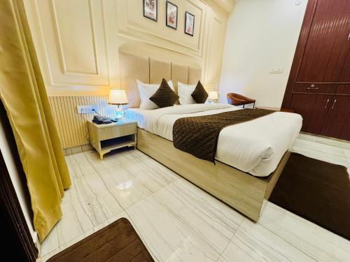 a hotel room with a large bed in a room at The Classic Crowne at Delhi Airport in New Delhi