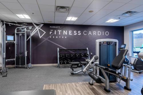 a gym with a fitness center with cardio equipment at Louisville Marriott Downtown in Louisville