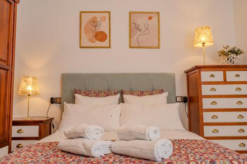 a bedroom with a bed with towels on it at LIVING CAZORLA II in Cazorla