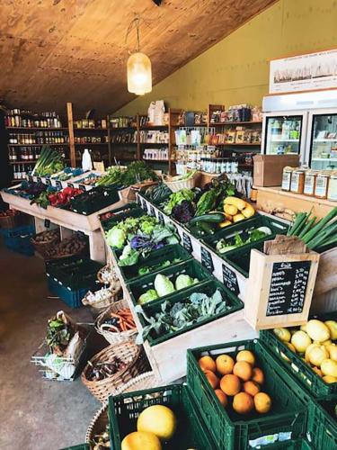 a grocery store filled with lots of fruits and vegetables at Shepherd's Hut a tiny ecohouse near Dwingelderveld in Ruinen