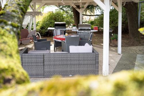 acovered patio with chairs and a table and a tablektop at Apartma Maka in Maribor