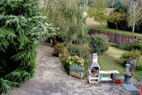 a garden with a bench and a table with flowers at Apartma Maka in Maribor