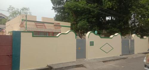 a fence with a painting on the side of it at Kriya Home Stays in Tiruvannāmalai