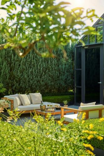 a garden with a couch and a coffee table at JW Marriott Hotel Seoul in Seoul