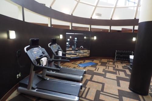 a gym with two tread machines in a room at Courtyard by Marriott Columbus West/Hilliard in Columbus