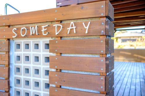 a sign that says someway written on a wooden wall at Surfing House SOMEDAY in Onjuku
