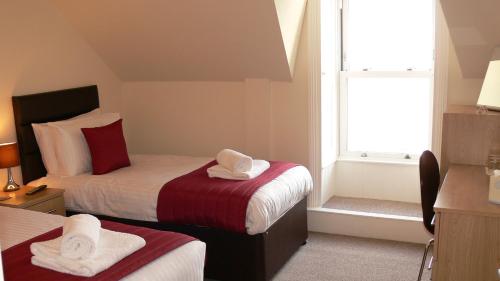 Ένα ή περισσότερα κρεβάτια σε δωμάτιο στο The Home Arms Guesthouse
