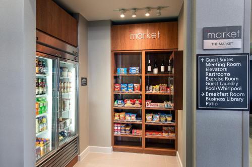 a grocery store with a refrigerator and shelves of food at Residence Inn San Diego Oceanside in Oceanside