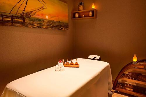 a table in a room with a white table cloth at Courtyard by Marriott Kochi Airport in Nedumbassery