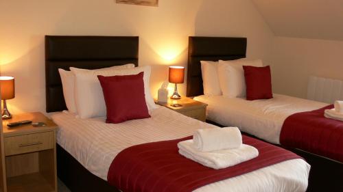 Ένα ή περισσότερα κρεβάτια σε δωμάτιο στο The Home Arms Guesthouse