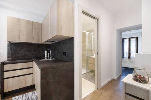 a kitchen with a sink and a mirror at Le Coccinelle Home in Mandello del Lario