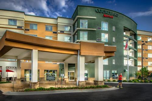 a person standing in front of a hotel at Courtyard by Marriott Charleston Downtown/Civic Center in Charleston