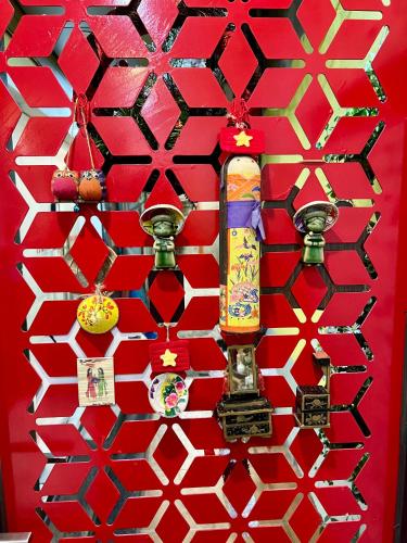 a red wall with a skateboard on it at Rik Homestay in Hanoi