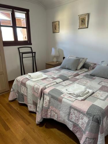 a bedroom with a bed with a blanket on it at La casa de Epi in Ziordia