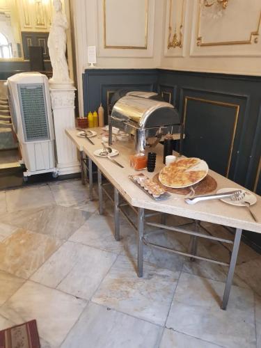 a table with a plate of food on it at Pharana Residence in Alexandria