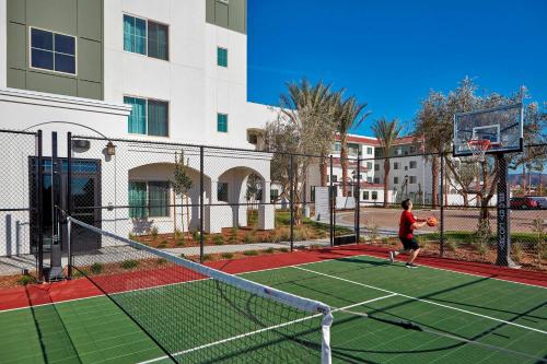 a man playing basketball on a tennis court at Residence Inn by Marriott San Diego Chula Vista in Chula Vista