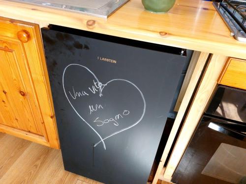 a refrigerator with a drawing of a heart on it at mansarda roulette in Saint Vincent