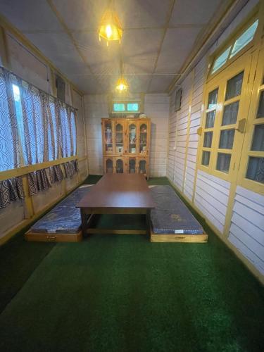 a room with a table in the middle of a room at Loseng Farm Stay in Rupa