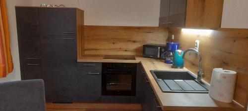 a kitchen with a sink and a stove top oven at Ferienhaus Vils in Vils