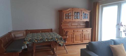 a living room with a table and a cabinet at Ferienhaus Vils in Vils