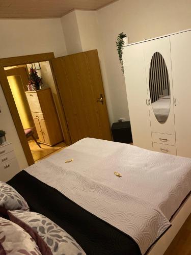 a bedroom with a large bed and a closet at Ferienwohnung An der Lutter in Bad Lauterberg