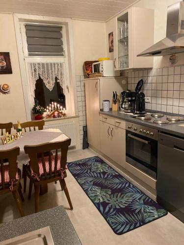 a kitchen with a table and a dining room at Ferienwohnung An der Lutter in Bad Lauterberg