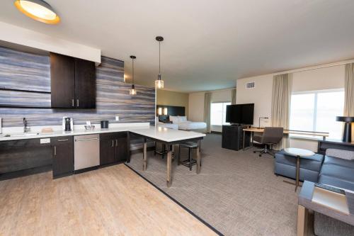 a kitchen and living room with a table and chairs at Residence Inn by Marriott Indianapolis South/Greenwood in Indianapolis