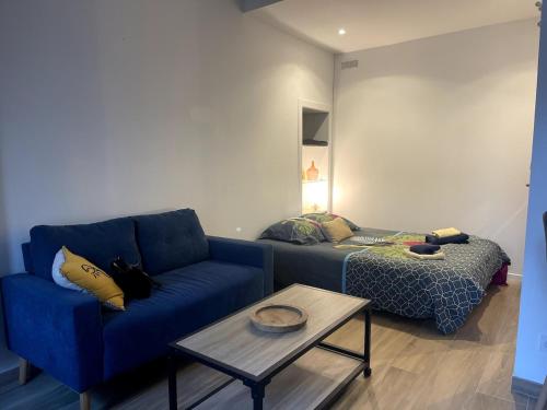 un salon avec un canapé bleu et une table dans l'établissement Ty Logis, à Vannes