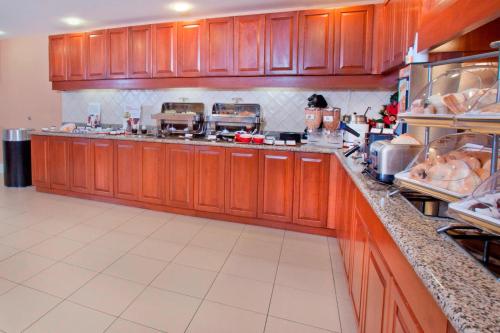 a large kitchen with wooden cabinets in a kitchen at Residence Inn Dover in Dover