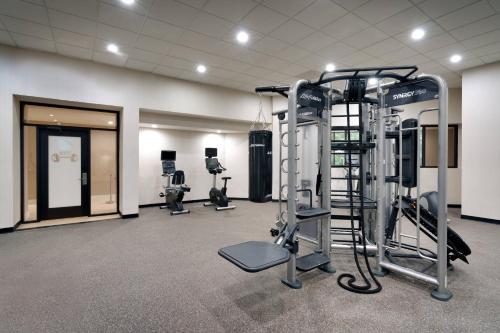 a gym with several tread machines in a room at Courtyard by Marriott Charlotte Airport LoSo in Charlotte