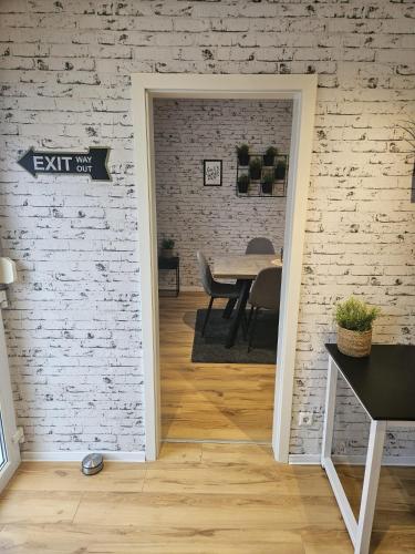 an exit sign in a room with a brick wall at Hakans moselblick Ferienwohnung 2 in Treis-Karden