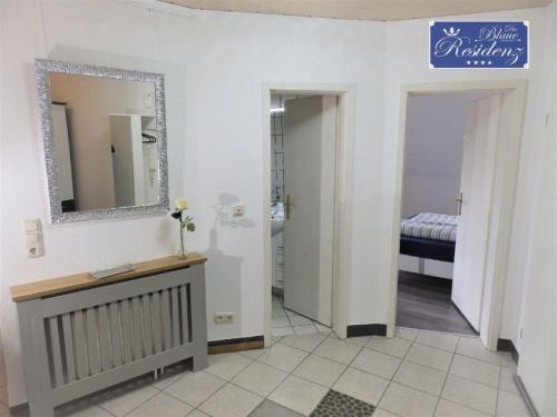 a bathroom with a vanity and a mirror and a sink at Saphir Suite in Westerdeichstrich
